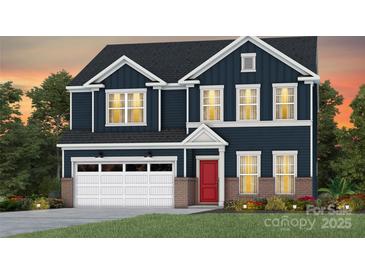 Charming new construction two-story home featuring a brick-accented facade, attached garage and inviting red front door at 2176 Millennium Dr # 093, Lancaster, SC 29720