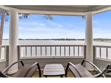 Relaxing screened porch featuring serene lake views and comfortable seating at 372 Northwest Dr, Davidson, NC 28036