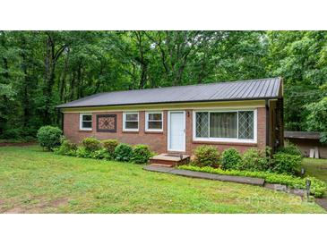 Charming brick home with metal roof, manicured landscaping, and decorative window accents at 4705 Campground View Rd, Catawba, NC 28609