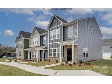 Charming townhomes with varied siding, brick accents, and well-maintained lawns showcase modern living at 5201 Shasta St # 5201, Gastonia, NC 28052