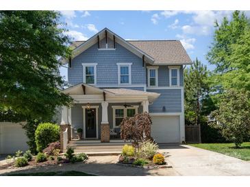 Charming two-story home featuring a covered front porch and well-manicured landscaping at 710 Morgan Park Dr, Charlotte, NC 28204