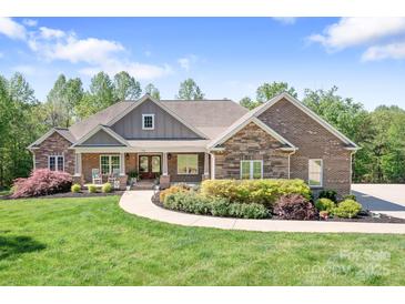 Charming brick and stone home with a manicured lawn and inviting front porch, perfect for enjoying peaceful surroundings at 730 Oak Ridge Farms Cir # 14, Newton, NC 28658