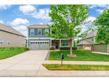 Charming two-story home with a two-car garage, well-maintained lawn and mature landscaping at 9109 Loch Glen Way, Charlotte, NC 28278