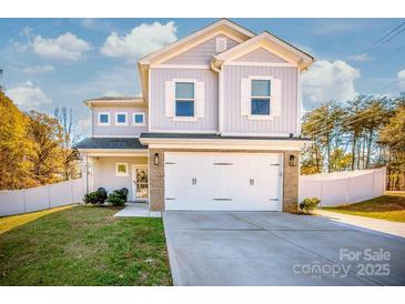 Charming two-story home features a brick-accented garage and a well-manicured lawn at 104 Trellis Ln, Troutman, NC 28166