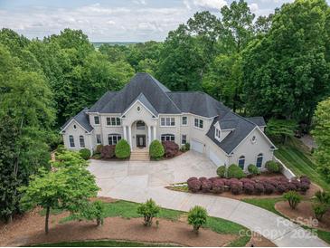 Expansive estate featuring a meticulously landscaped yard, a grand home, and surrounding lush greenery at 110 Cramer Mountain Woods None, Cramerton, NC 28032