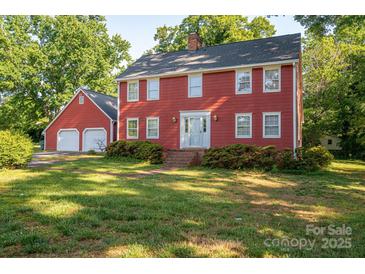 Charming two-story home with a well-maintained lawn and matching detached two-car garage at 2240 Armstrong Park Dr, Gastonia, NC 28054