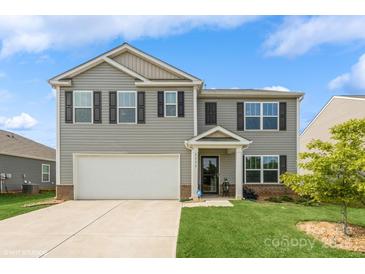Charming two-story home featuring a well-maintained lawn, a two-car garage, and a welcoming entrance at 2772 Sherrills Stream Dr, Sherrills Ford, NC 28673