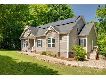 Charming home with solar panels, American flag, and well-maintained lawn at 3243 Farmcrest Ct, Fort Mill, SC 29708