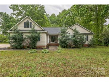 Charming single-story home with a well-maintained front yard and classic architectural details at 3585 Goodman Lake Rd, Salisbury, NC 28146