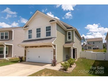 Two-story home boasts manicured lawn, attached garage, and a welcoming entrance at 507 Newfound Hollow Dr, Charlotte, NC 28214