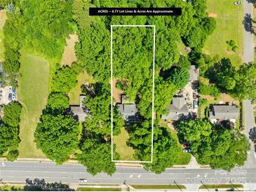 Aerial view of wooded lot showing approximate property lines and nearby street access at 6012 Tuckaseegee Rd, Charlotte, NC 28208