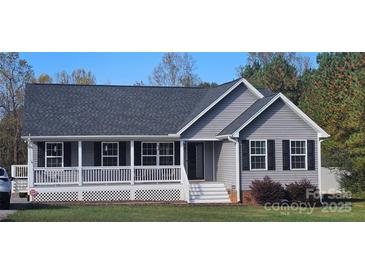 Charming single-story home with a welcoming front porch, black shutters, and landscaped lawn at 6300 Bill Sain Rd, Vale, NC 28168