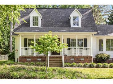 Charming home featuring a covered front porch and well-maintained landscaping at 709 Weldon Ln, Salisbury, NC 28146