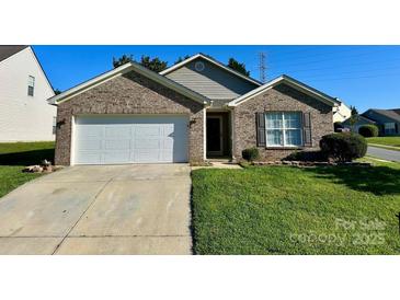 Charming brick home with well-maintained lawn and attached two-car garage, offering curb appeal at 8551 Appledale Dr, Charlotte, NC 28262