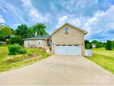 Charming brick home with a two-car garage and well-manicured lawn on a partly cloudy day at 970 Mt Moriah Church Rd, China Grove, NC 28023