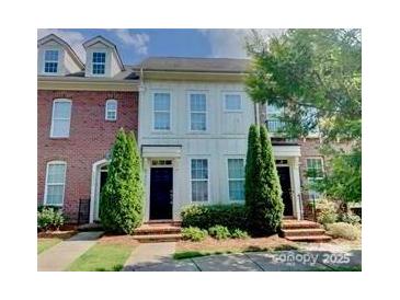 Charming townhome with well-maintained landscaping and a welcoming entrance at 9832 Longstone Ln, Charlotte, NC 28277