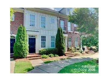 Charming townhome with well-maintained landscaping, brick facade, and inviting front entrance at 9832 Longstone Ln, Charlotte, NC 28277