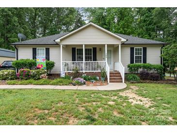 Charming single-story home with a cozy front porch, mature landscaping, and a well-maintained lawn at 195 Kings Ter, Salisbury, NC 28146
