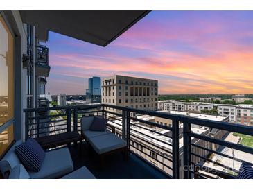 Relaxing condo balcony featuring comfortable lounge chairs and breathtaking city views at sunset at 333 W Trade St # 805, Charlotte, NC 28202
