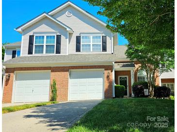 Charming two-story home with a two-car garage, brick accents, and well-manicured lawn at 3412 Summerfield Ridge Ln, Matthews, NC 28105