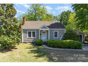 Charming one-story home features a manicured lawn, mature trees, and a welcoming front entrance at 3612 The Plz, Charlotte, NC 28205