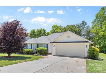 Charming home featuring a two-car garage, well-manicured lawn, and a beautiful red Japanese maple tree at 3744 Leela Palace Way, Fort Mill, SC 29708