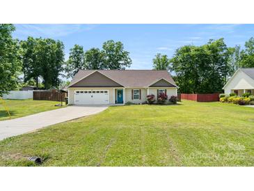 Charming single-story home featuring a well-manicured lawn, attached garage, and a delightful blue front door at 5057 Sedgefield Dr, Lancaster, SC 29720