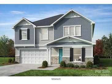 Charming two-story home with a light blue door, gray siding, stone accents, and a two-car garage at 1001 Cunningham Farm Dr, Indian Trail, NC 28079