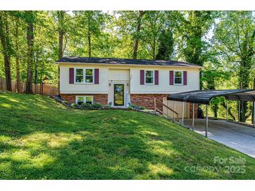 Charming split-level home with red shutters, a brick foundation, and a convenient carport at 1018 Autumn Ln, Hickory, NC 28602