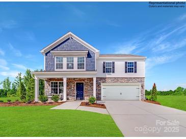 Beautiful two-story home with stone accents, a covered porch, and a well-manicured lawn at 1092 Old Trade St, Edgemoor, SC 29712