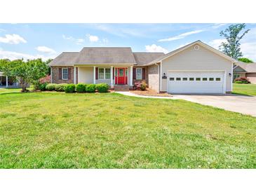 Charming single-story home with a well-manicured lawn, bright red door, and attached two-car garage at 110 Carol Lyn Dr, Kings Mountain, NC 28086