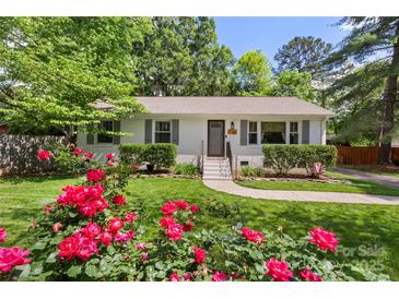 Beautiful home with vibrant landscaping and a well-maintained front lawn and walkway at 301 Deer Creek Dr, Matthews, NC 28105