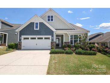Charming home featuring a two-car garage, stone accents and manicured lawn at 309 Kentmere Ln, Clover, SC 29710