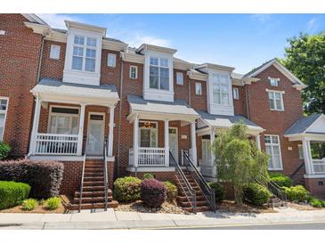 Charming red brick townhomes with inviting front porches and professional landscaping at 4941 S Hill View Dr, Charlotte, NC 28210