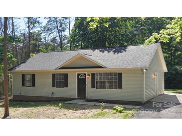 Charming single story home with black shutters and a well-maintained front yard at 7525 Cedarbrook Dr, Charlotte, NC 28215