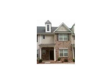 Charming townhome featuring brick and neutral siding, complemented by neatly trimmed windows at 8641 Wandering Creek Way, Charlotte, NC 28227