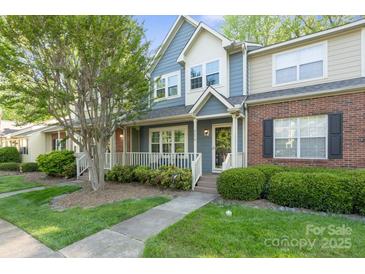 Charming blue townhome with a well-maintained front yard and inviting porch at 9214 Arbourgate Meadows Ln, Charlotte, NC 28277