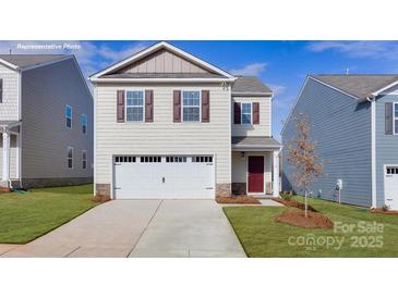 Charming two-story home features a two-car garage and manicured lawn at 1033 20Th Avenue Se Loop, Hickory, NC 28602