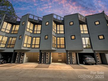 Contemporary townhome exterior with private driveways and modern architectural design at 1054 Kenilworth Ave, Charlotte, NC 28204
