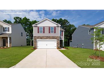 Charming two-story home with a two-car garage and a well-manicured lawn at 1064 20Th Avenue Se Loop, Hickory, NC 28602