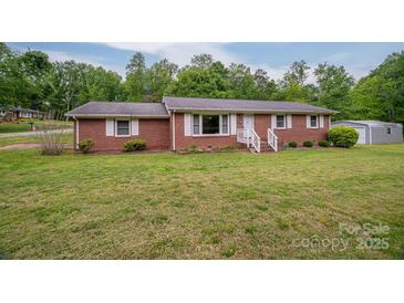 Charming single-story brick home featuring a well-manicured lawn and complementing white shutters at 115 Patterson Rd, Kings Mountain, NC 28086