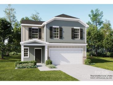 Charming two-story home with a two-car garage, green lawn, and tasteful landscaping at 155 Astor St, Troutman, NC 28166