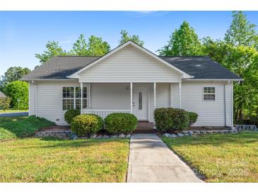 Charming single story home with a welcoming front porch, manicured bushes, and a well-kept lawn at 1806 Red Bird Cir, Concord, NC 28025