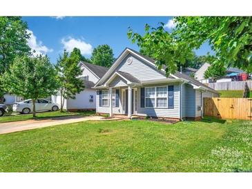 Charming single-story home with blue shutters, well-manicured lawn, and mature trees offering ample shade at 2126 Downing St, Charlotte, NC 28205
