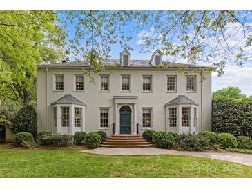 Elegant white brick two-story home with mature landscaping, dormer windows, and a beautiful teal front door at 2322 Hopedale Ave, Charlotte, NC 28207