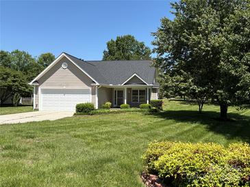 Charming single-story home features a well-manicured lawn and attached garage, with shade tree at 2800 Deans Ct, Monroe, NC 28110