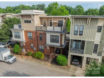 A modern townhouse with a rooftop terrace and unique architectural details at 2988 Textile Way, Charlotte, NC 28205