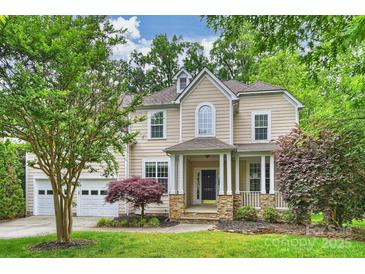 Two story traditional home with a manicured lawn and an attached two car garage at 427 Pinnacle Ln, Huntersville, NC 28078