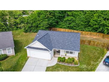 Aerial view of a charming home with a well-maintained lawn and a fenced backyard at 6808 Squirrels Foot Ct, Charlotte, NC 28217