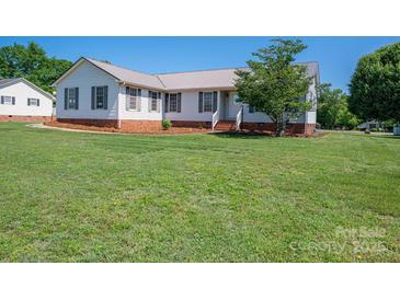 Inviting single-story home with manicured lawn and lush landscaping at 727 Skinner Rd, Shelby, NC 28152